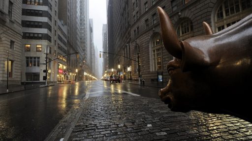 The Wall Street bronze Bull looks out to an empty Broadway